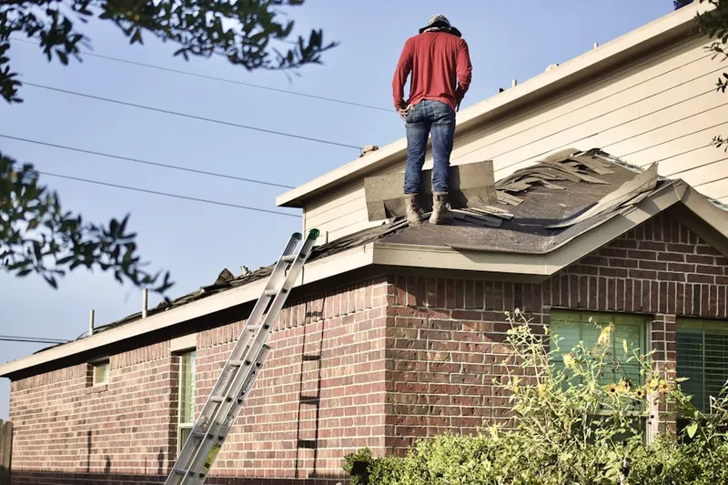 Professional roofer working on a residential roof in Princeton Walk